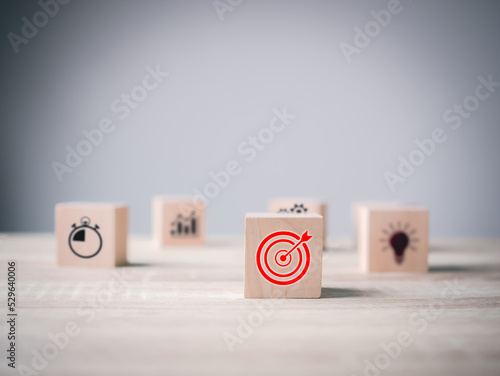 Business goal target achievement concept of business strategy and action plan on wooden cube block icon, copy space background
