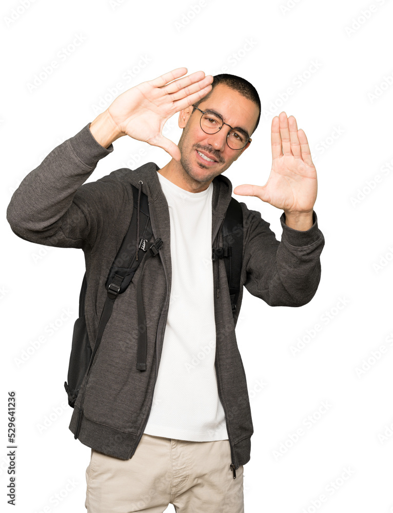Friendly student making a gesture of taking a photo with the hands Friendly student making a gesture of taking a photo with the hands