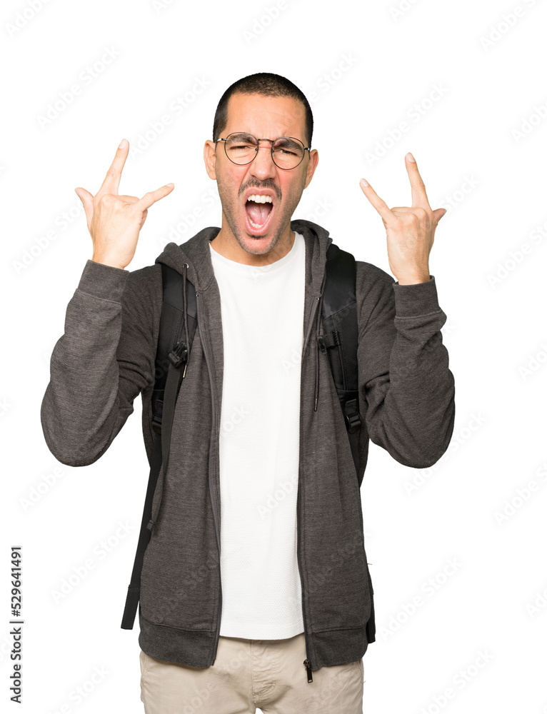 Naughty student making a rock gesture Naughty student making a rock gesture