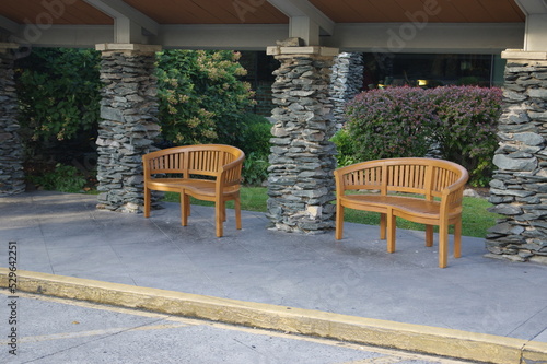 Wood benches between stacked stone columns