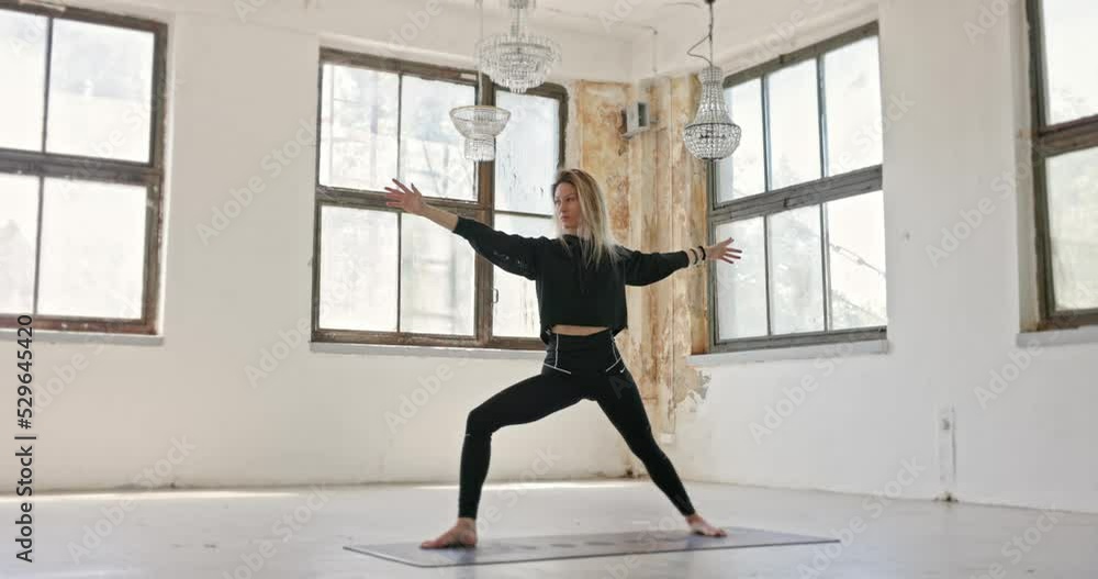 Dynamic camera movement on woman doing yoga in industrial interior Dynamic camera movement on woman doing yoga in industrial interior