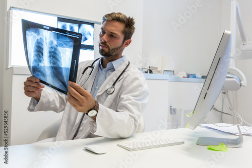  pulmonologist Doctor looks at a chest x-ray - clinic medical concept photo