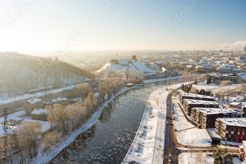 Beautiful Vilnius city panorama in winter with snow covered houses, churches and streets. Aerial evening view. Winter city scenery in Lithuania.