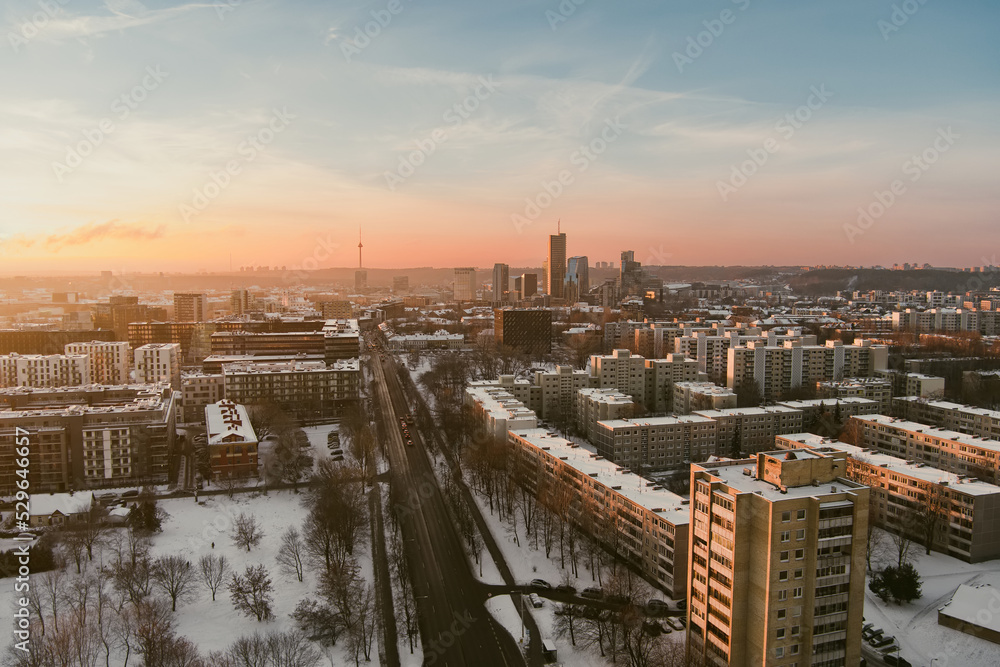 Beautiful Vilnius city panorama in winter with snow covered houses, churches and streets. Aerial evening view. Winter city scenery in Lithuania. Beautiful Vilnius city panorama in winter with snow covered houses, churches and streets. Aerial evening view. Winter city scenery in Lithuania.