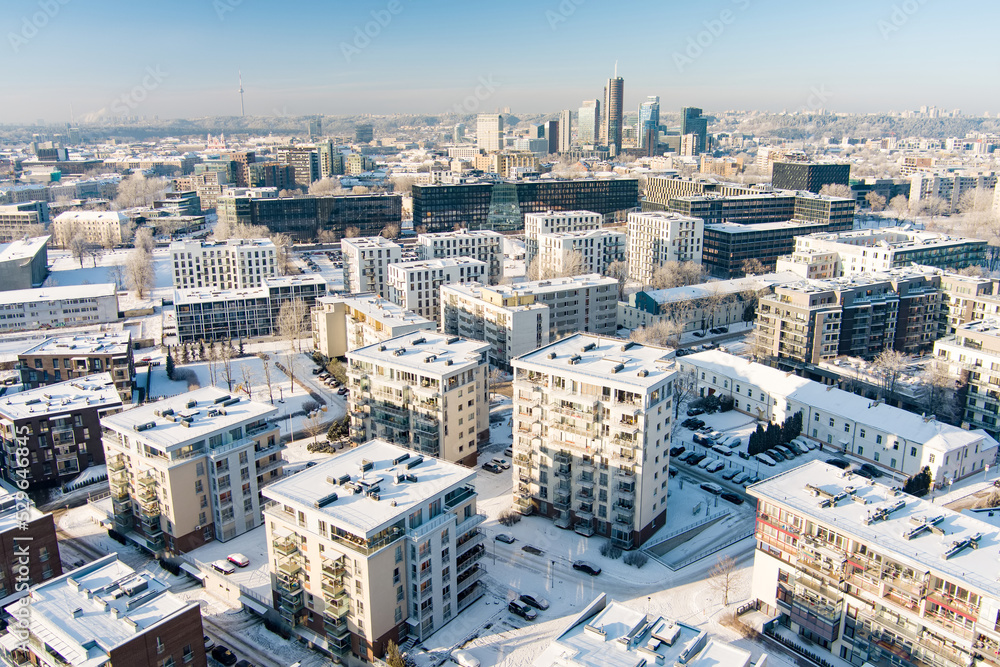 Aerial panorama of residential area of Vilnius in winter with snow covered houses and streets. Winter city scenery in Lithuania.