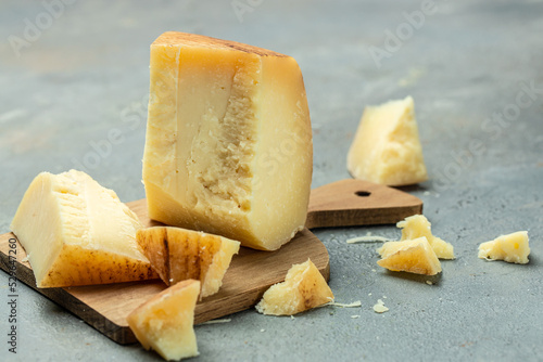 Traditional Gravyer Gruyere Cheese hard yellow cheese without holes, with a dark crust and a pleasant floral and nutty aroma, place for text, top view photo