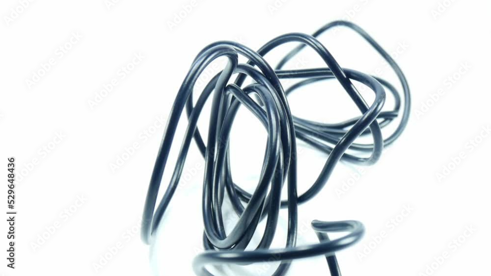 Black wire cable of usb and adapter isolated on white background.Electronic Connector.Selection focus.Slow motion macro footage. Black wire cable of usb and adapter isolated on white background.Electronic Connector.Selection focus.Slow motion macro footage.