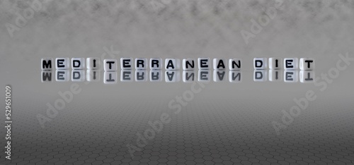 mediterranean diet word or concept represented by black and white letter cubes on a grey horizon background stretching to infinity