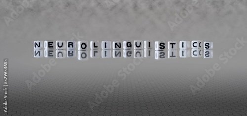 neurolinguistics word or concept represented by black and white letter cubes on a grey horizon background stretching to infinity photo