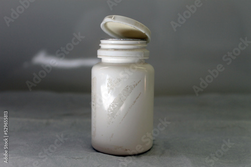  white pill bottle with pills on the table