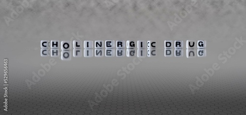 cholinergic drug word or concept represented by black and white letter cubes on a grey horizon background stretching to infinity