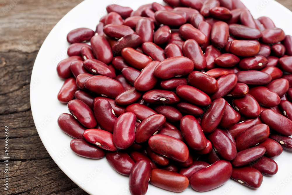 Red bean kidney in white dish on old wooden background. Red bean kidney in white dish on old wooden background.