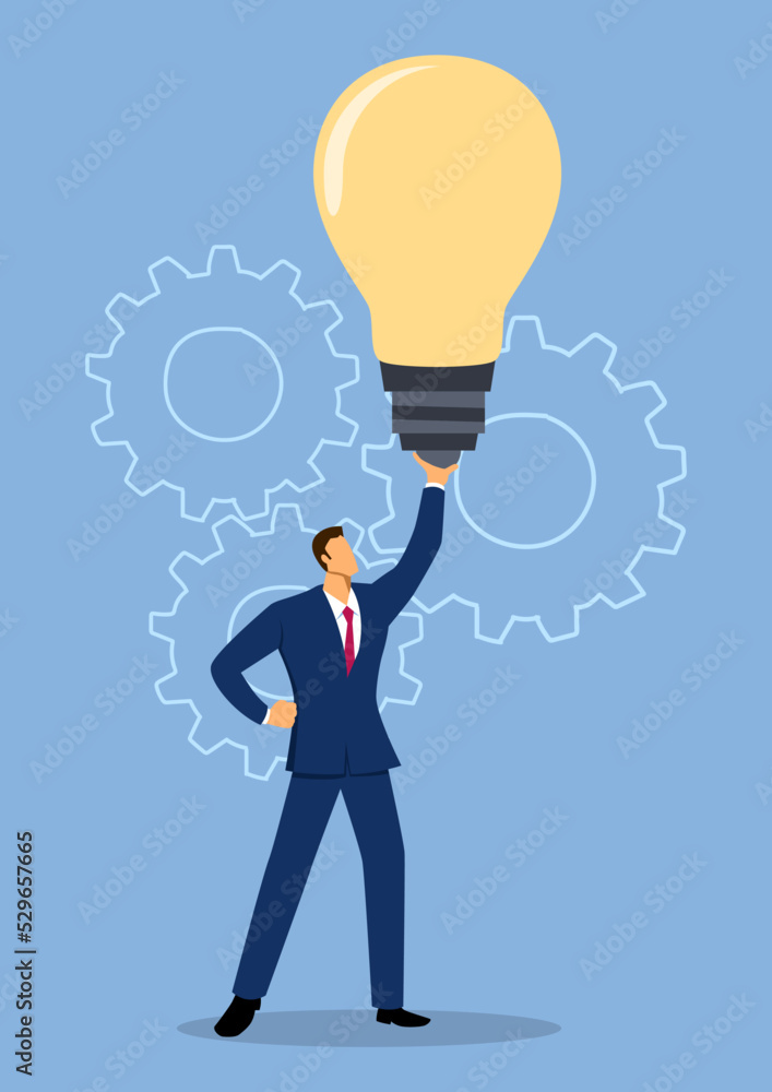 Businessman holding up a giant light bulb Businessman holding up a giant light bulb