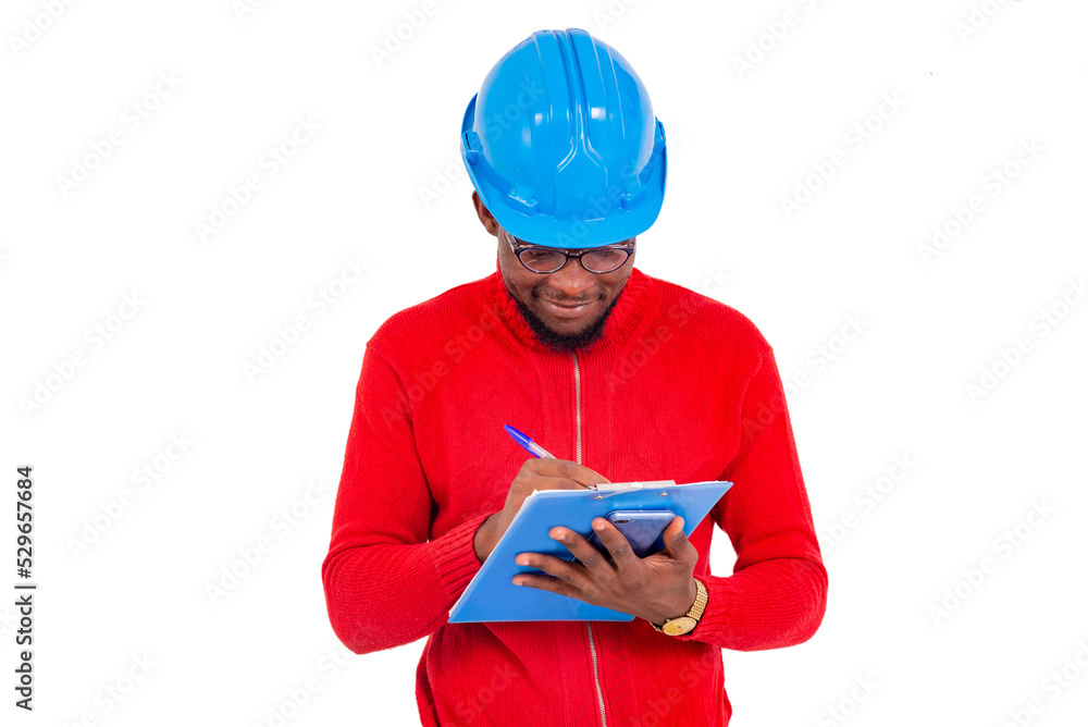 portrait of an engineer writing on a notepad, smiling. portrait of an engineer writing on a notepad, smiling.