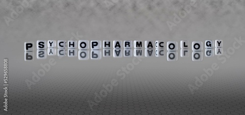 psychopharmacology word or concept represented by black and white letter cubes on a grey horizon background stretching to infinity photo