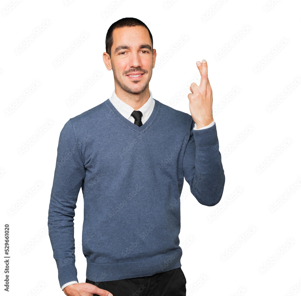 Happy young man doing a crossed fingers gesture Happy young man doing a crossed fingers gesture