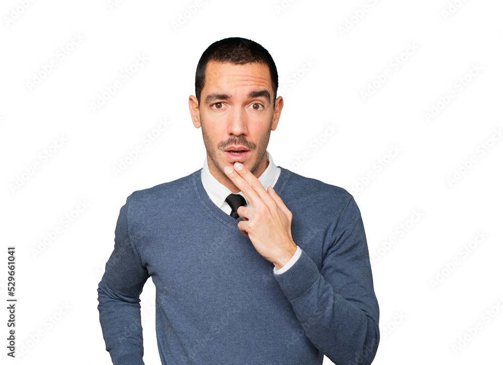 Concentrated young man making a gesture of distrust Concentrated young man making a gesture of distrust