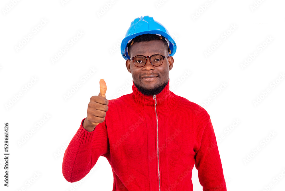 young man engineer showing his thumb up smiling. young man engineer showing his thumb up smiling.