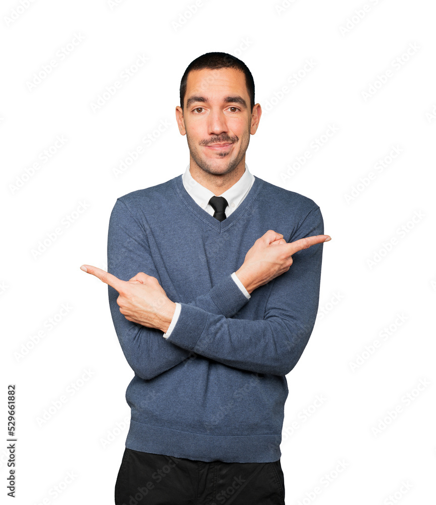 Confused young man poiting in both directions Confused young man poiting in both directions