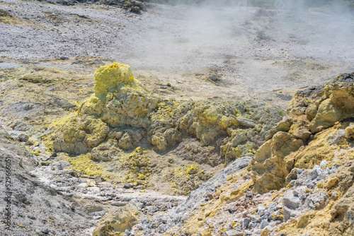 smoking solfatara in a fumarole field on the slope of the Mendeleev volcano