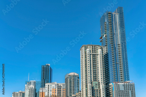 Towering modern luxury apartments against blue sky background on a sunny day