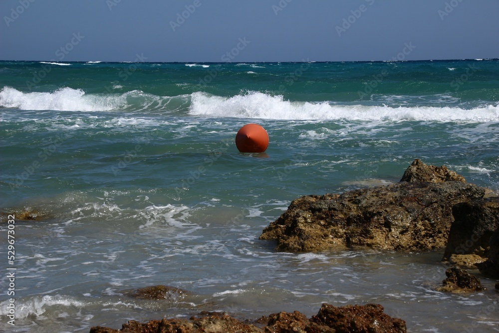 Italy: Red buoy in the sea of ​​Salento.