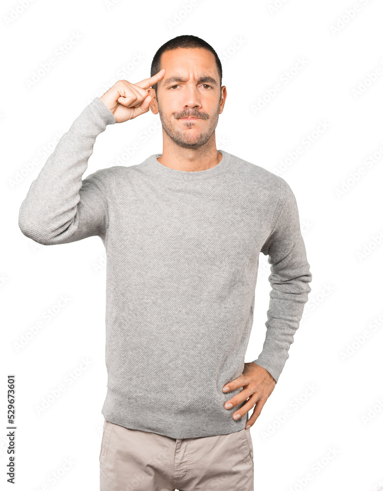 Serious young man doing a gesture of concentration Serious young man doing a gesture of concentration