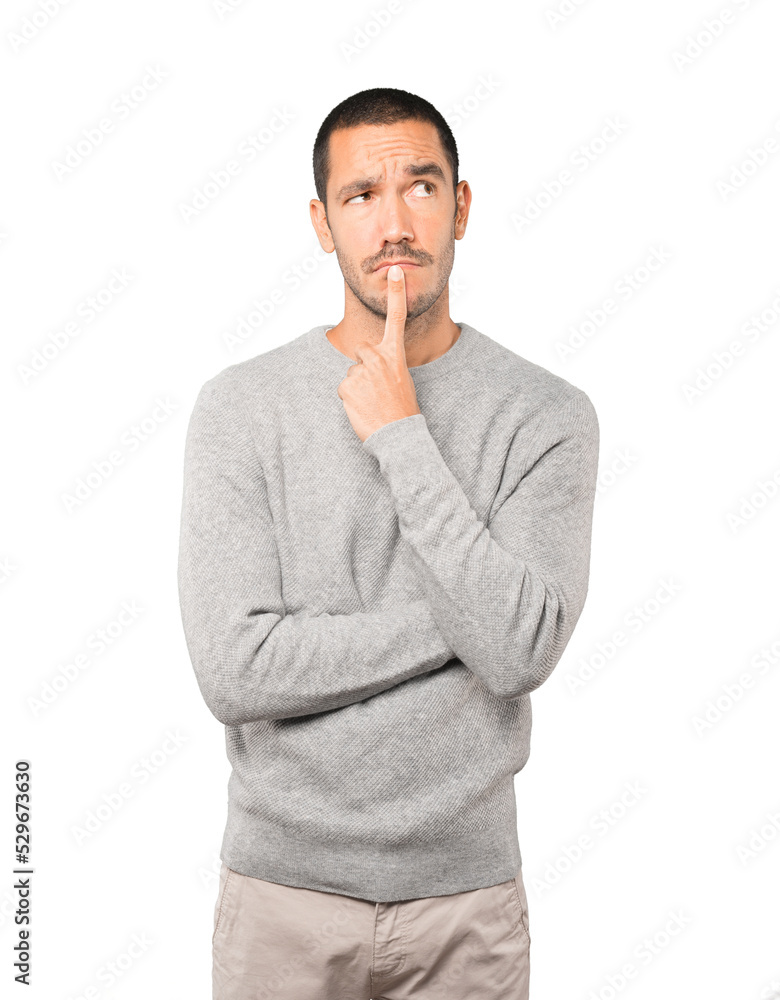 Concerned young man doing a gesture of confusion Concerned young man doing a gesture of confusion