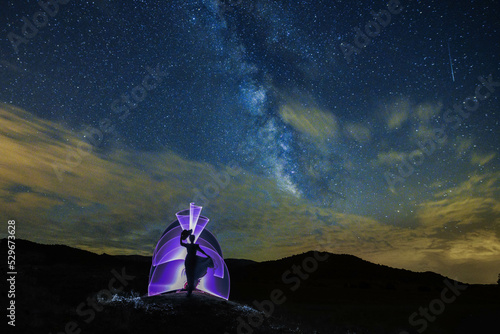 Night photography, light painting with the milky way in the background. photo