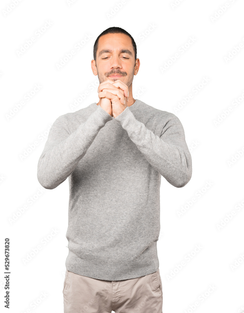 Serious young man making a gesture of strength Serious young man making a gesture of strength
