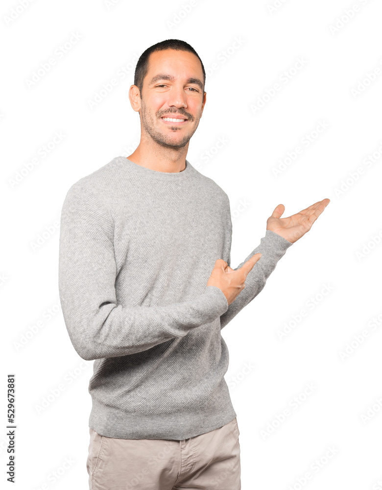Friendly young man making a gesture of welcome Friendly young man making a gesture of welcome