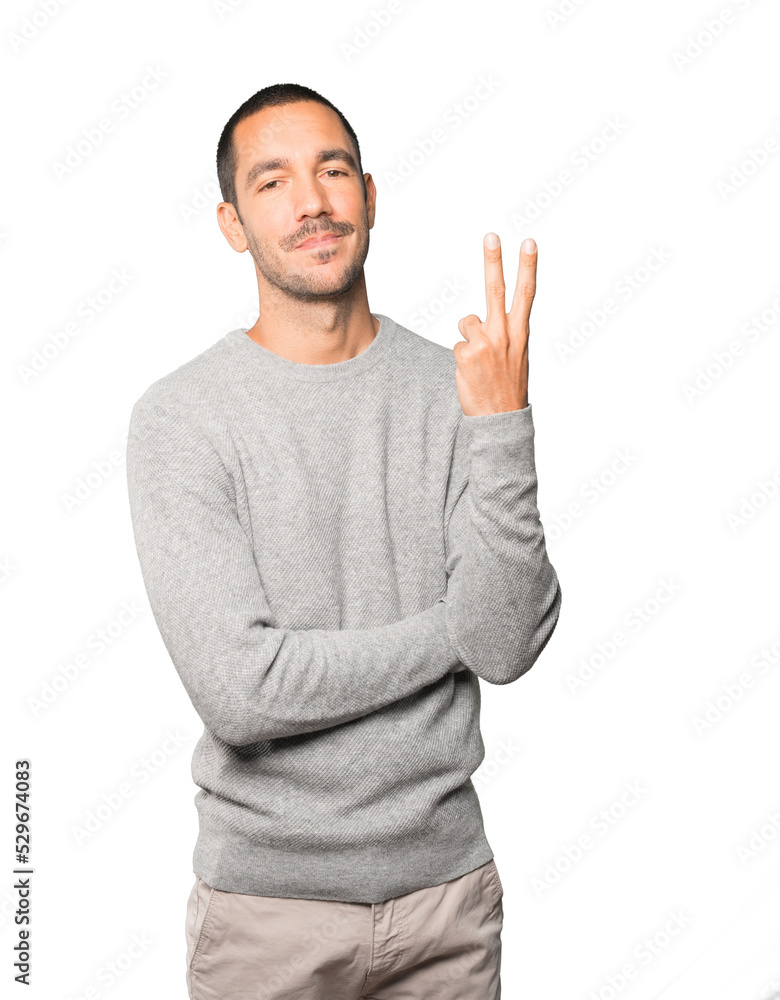 Young man making a number two gesture Young man making a number two gesture