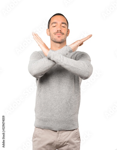 Young man making a gesture of not crossing with the arms photo