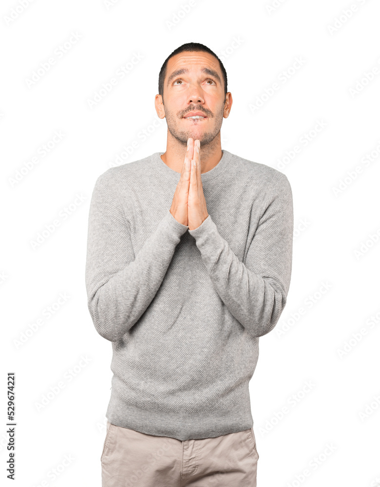 Happy young man praying gesture Happy young man praying gesture