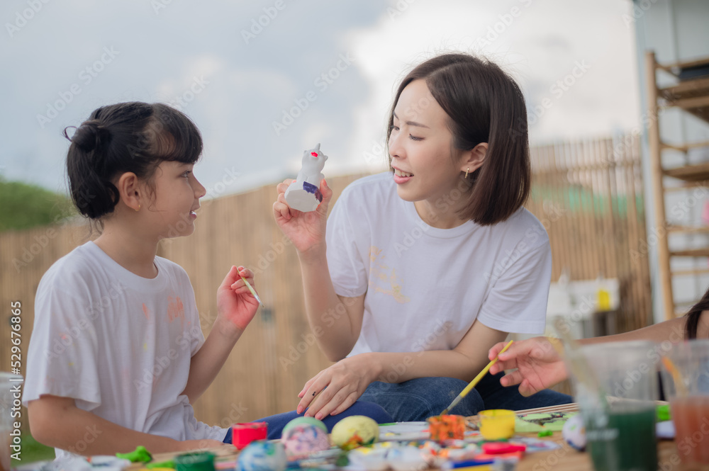 mother and daughter studying art draw a doll mother and daughter studying art draw a doll