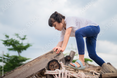 Asian Girl playing on playground, happy little Asia girl child having fun to playing in the playground