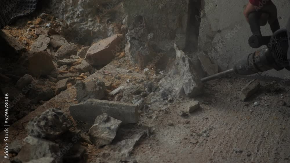 Worker drilling concrete on construction site. Using drill on demolition site Worker drilling concrete on construction site. Using drill on demolition site