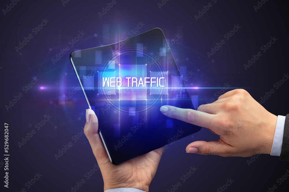 Businessman holding a foldable smartphone Businessman holding a foldable smartphone