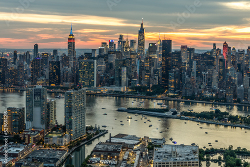 New York City Aerial view at sunset empire state building one vanderbilt, chrysler building fdr drive American colors east river boats