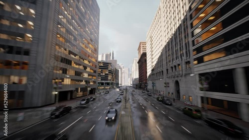 Low flying aerial dolly shot flying above multi lane highway through urban city center with skyscrapers