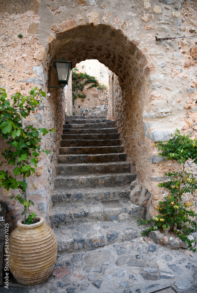 Street scene with steps and arched doorway in Monemvasia, Greece