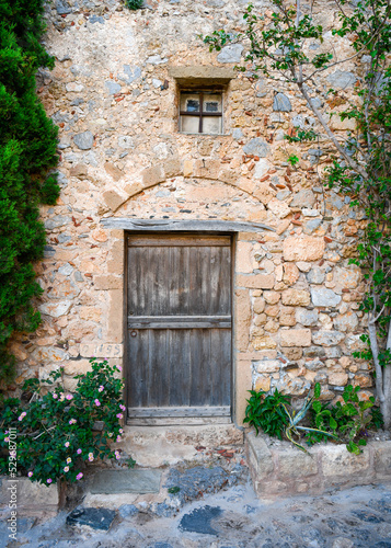 Medieval wooden door of stone building in Monemvasia, Greece