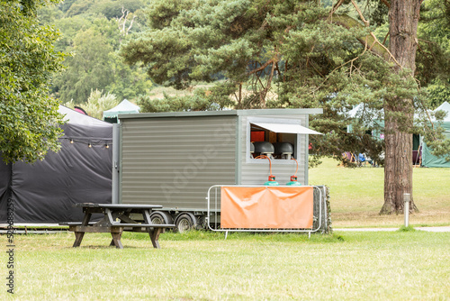 a food truck in a woodland setting, space for text, street food concept