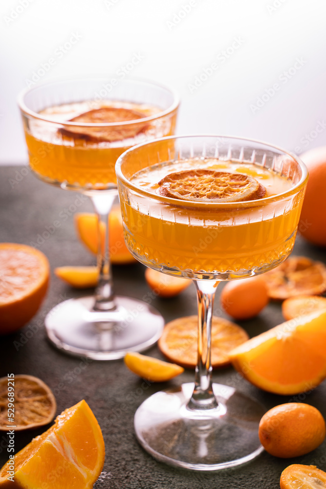 orange vodka tequila gin tonic mandarin cocktail with special cocktail glasses, dried oranges kumquats on background orange vodka tequila gin tonic mandarin cocktail with special cocktail glasses, dried oranges kumquats on background