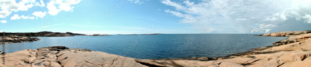 panorama of coastline with cliffs, sea and blue sky