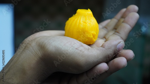 Lord Ganesha's Prasad Modak in hand photo