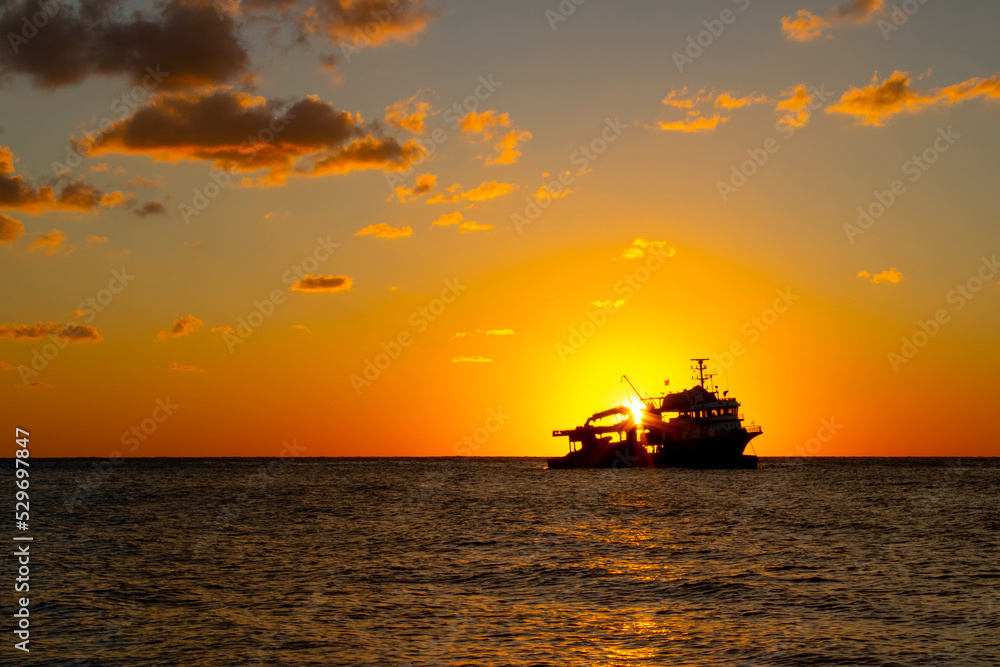 Sunset on the beach. Fishing boat
