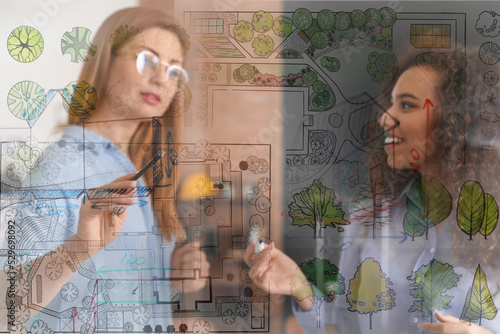 Double exposure of sketch and landscape designers discussing project in office