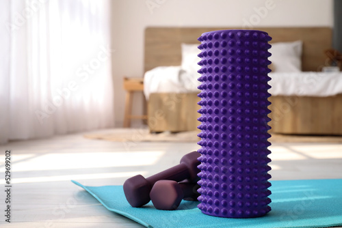 Foam roller and dumbbells o...