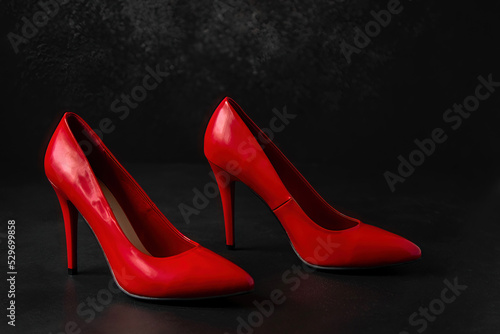 red women's shoes on a black background